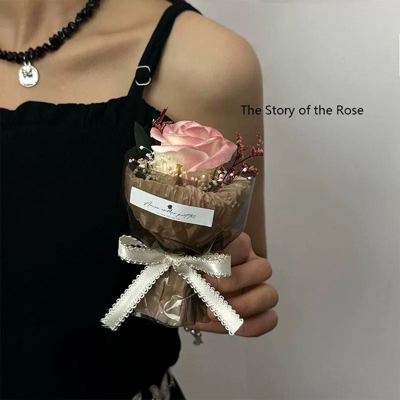A series of four mini pocket rose bouquets in clear plastic boxes, each with a different color rose, displayed on a dark surface.
