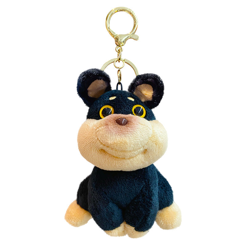 Plush dog keychain with a black sweater on a white background