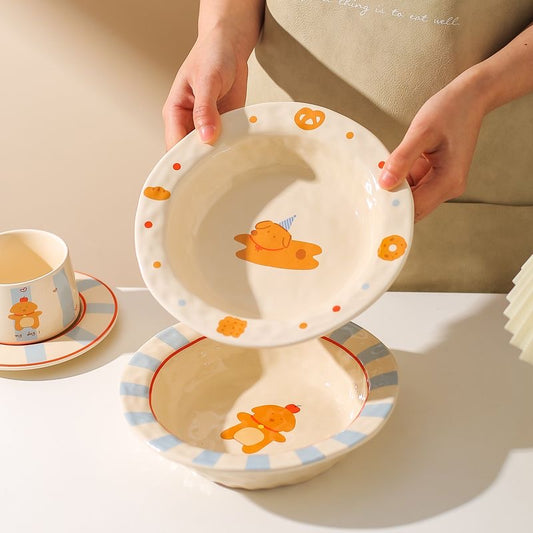Children's ceramic tableware set with cartoon designs on a neutral background