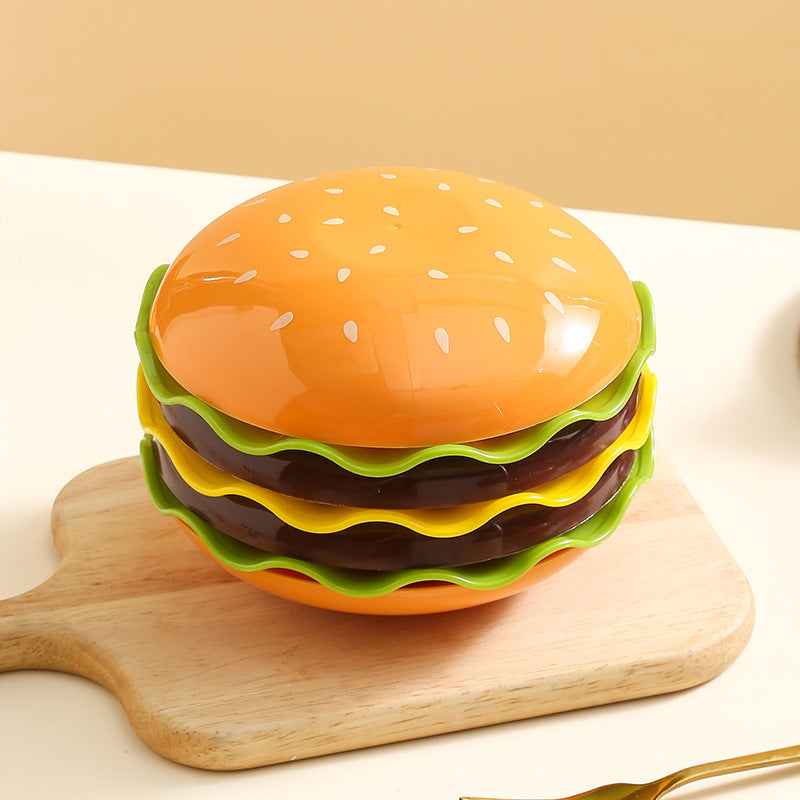 Hamburger-shaped container on a wooden board with a beige background
