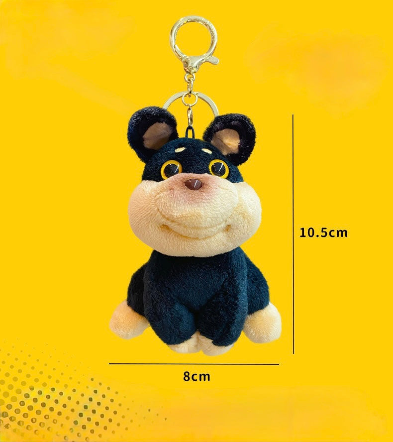 Plush dog keychain with measurements on a yellow background