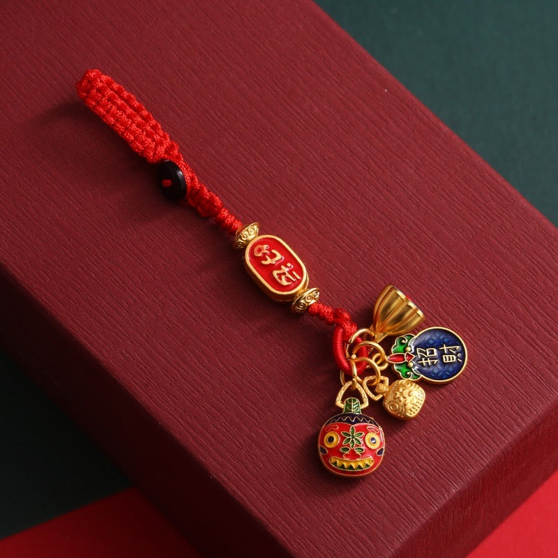 A red lucky charm hanging ornament with intricate details and traditional Chinese elements, featuring various auspicious symbols and knots.