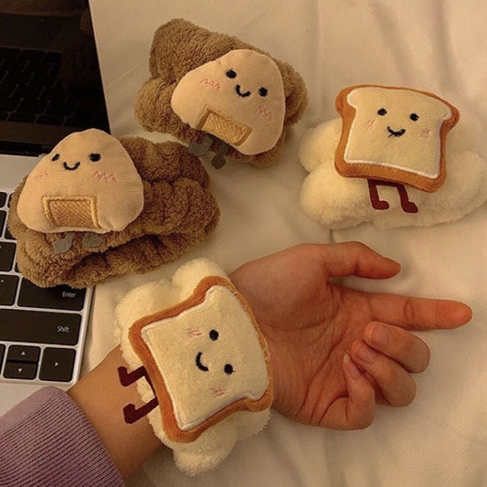 Cute plush wrist water absorbers in toast and rice ball designs, worn on the wrist to prevent water drips.