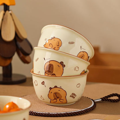 Set of three cartoon bear bowls stacked on a table with a blurred background