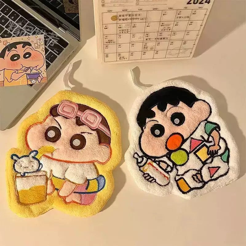 Two cartoon character patches on a desk with a laptop and calendar in the background.