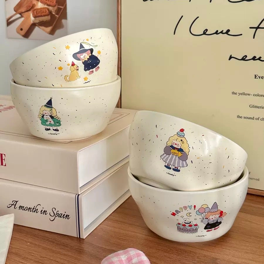 Set of white bowls with cartoon character designs on a wooden surface.