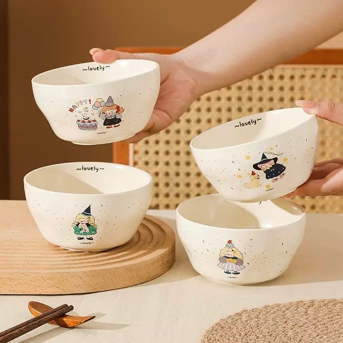 Set of four white bowls with cartoon characters on a wooden surface.