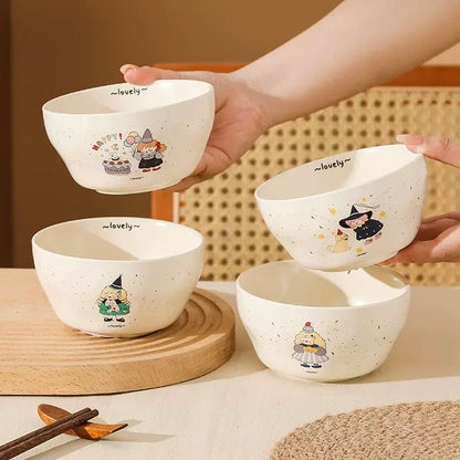 Set of four white bowls with cartoon characters on a wooden surface.