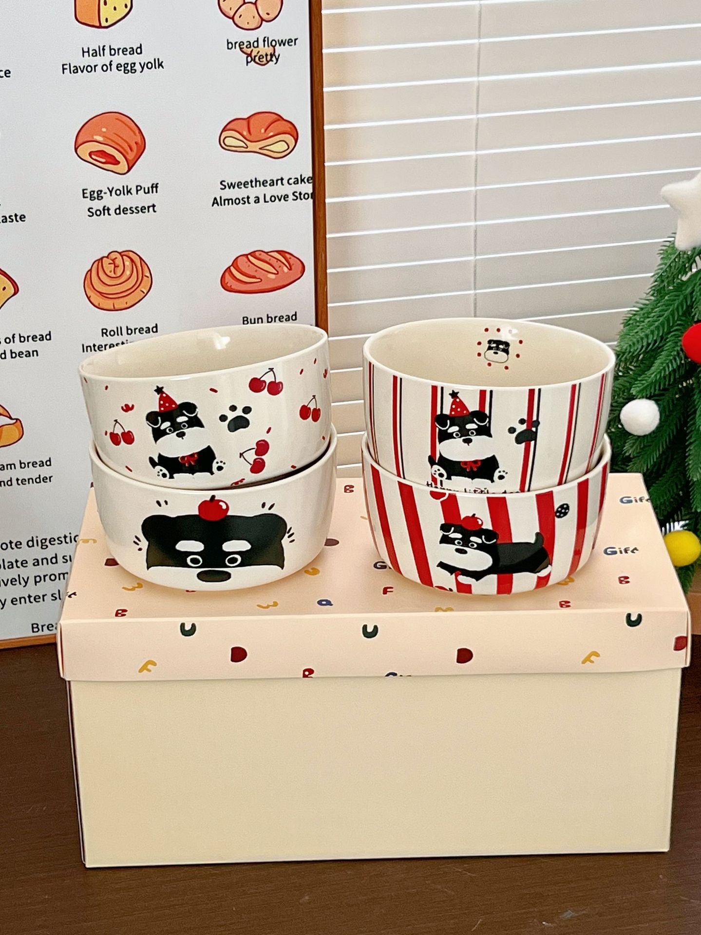 Set of ceramic bowls with cat designs on a wooden box
