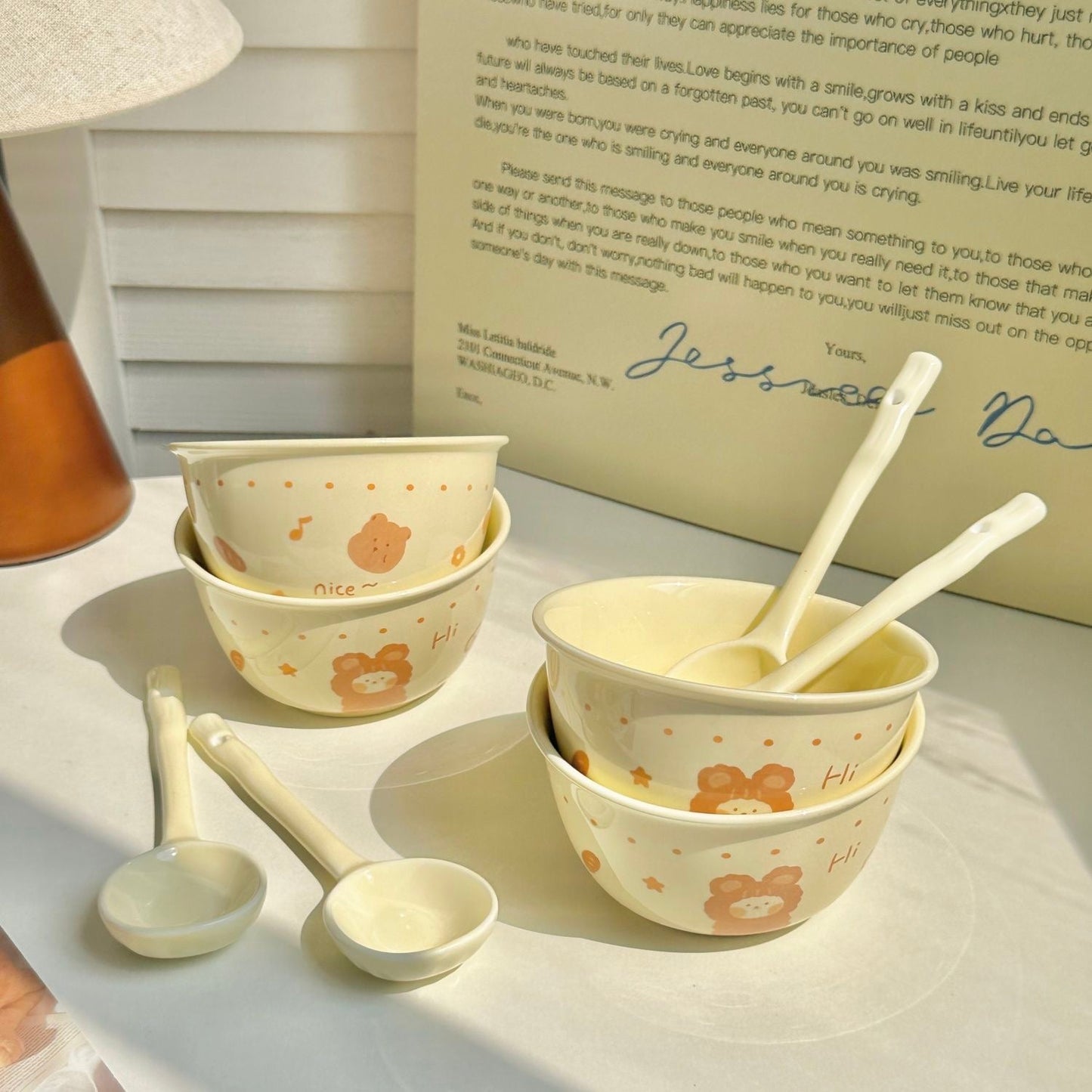 Cute bear-themed ceramic bowl set with matching spoons, perfect for daily use.