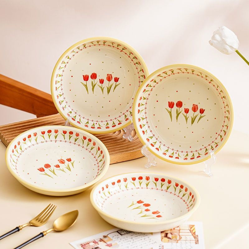 Tulip Bliss Ceramic Plate Set with hand-painted floral design, placed on a wooden tray with decorative items.