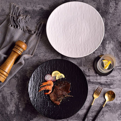 Minimalist textured ceramic dinner plate in black and white with matte finish, ideal for modern table settings.