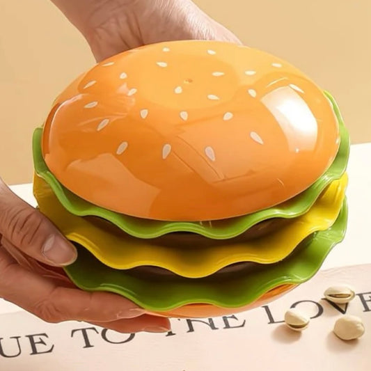 Stack of colorful hamburger-shaped plates held by a hand on a light background
