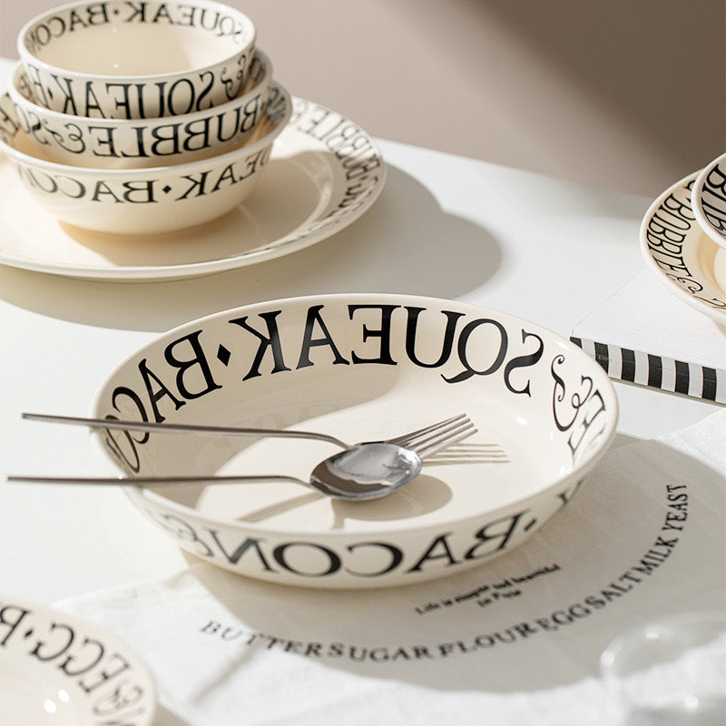 Set of ceramic bowls with text design on a white surface