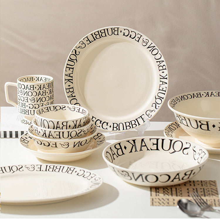 Ceramic dinnerware set with text design on a neutral background