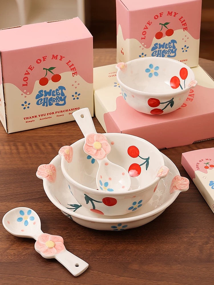 Ceramic bowl set with cherry design on a wooden surface, featuring 'Love of My Life Sweet Cherry' packaging.