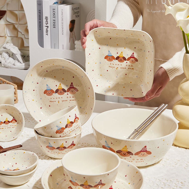 Set of ceramic bowls with cartoon designs on a table.