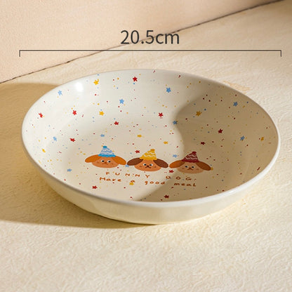 Ceramic bowl with cartoon designs and text, placed on a light surface.