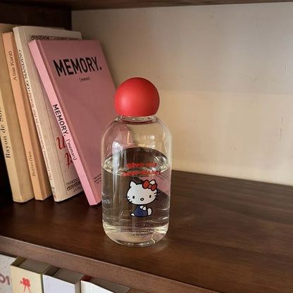 Clear bottle with red cap on a shelf next to books