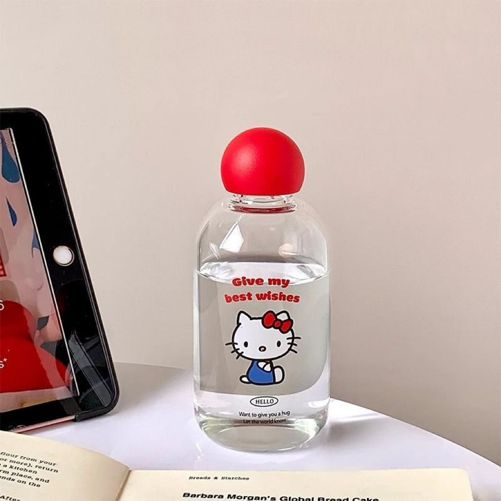Clear bottle with red cap and Hello Kitty label next to a smartphone on a light surface.