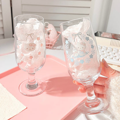 Two decorative glass goblets with cartoon character designs on a pink tray.