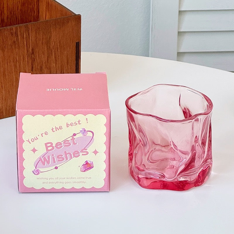 A collection of irregular glass cups with a wavy texture, displayed in various translucent colors such as pink, blue, and green, without packaging.