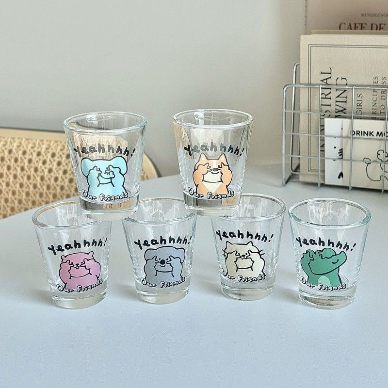 Set of six glass shot glasses with animal illustrations and 'YEAHHH!' text on a white surface.