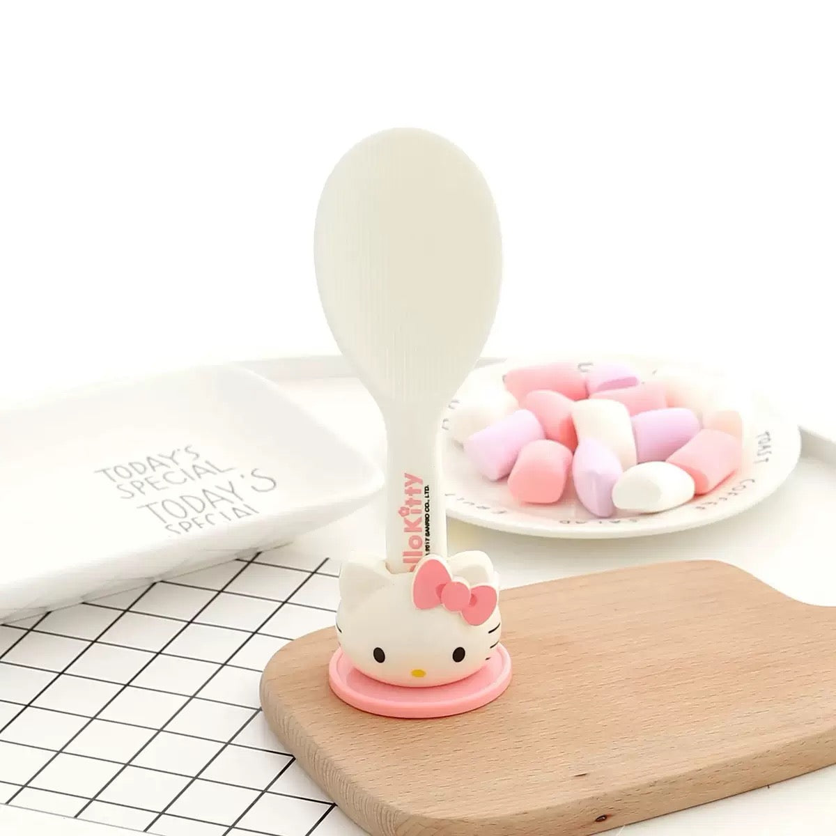 Hello Kitty-themed product on a wooden board with a white background