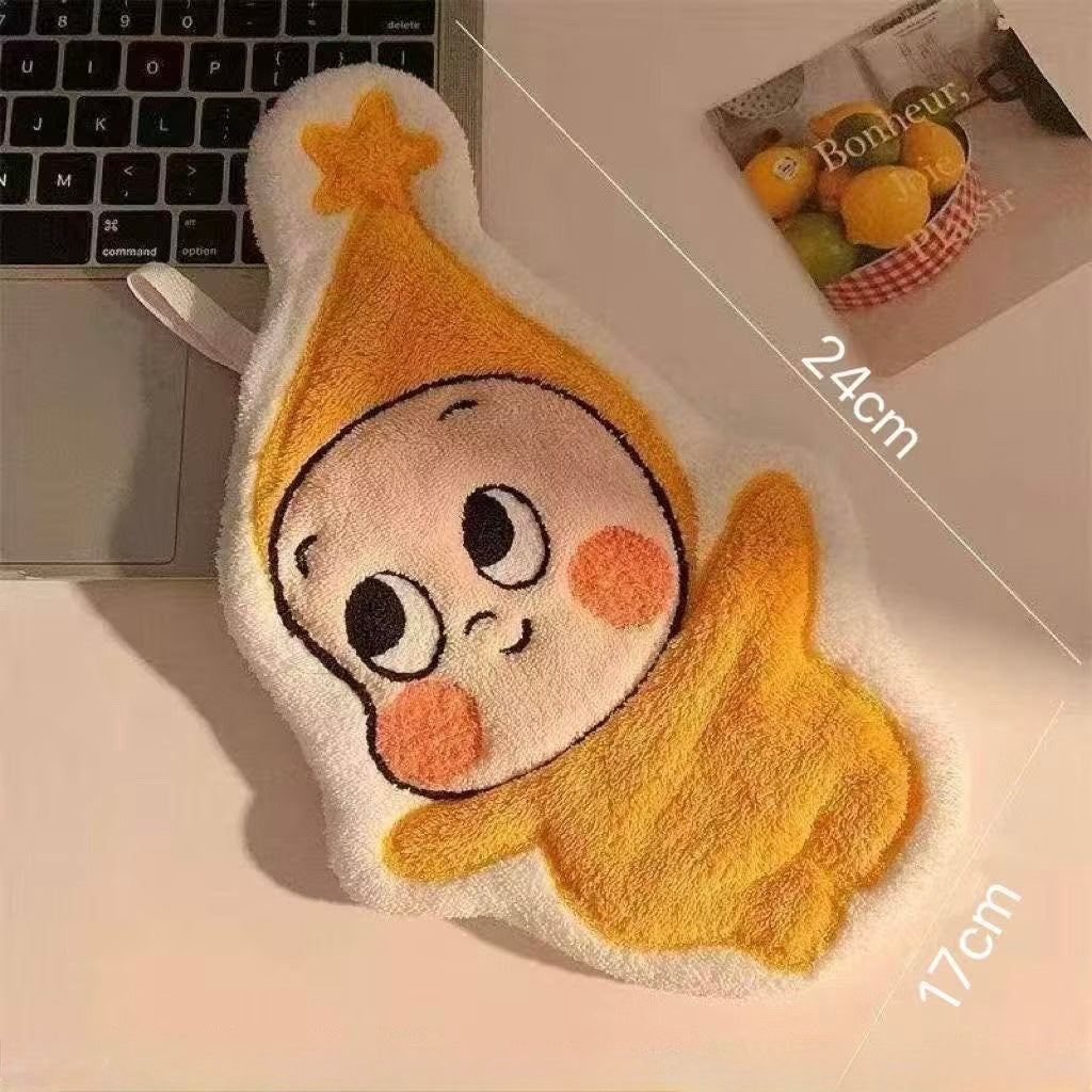 Plush toy with twinkle cartoon face on a desk next to a laptop