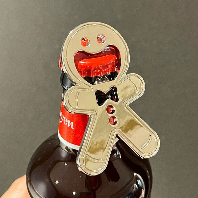 Stainless steel gingerbread man-shaped bottle opener with a smiling face, bowtie, and cut-out details, designed for easy cap removal. A fun and festive kitchen gadget perfect for holiday parties and gifts.