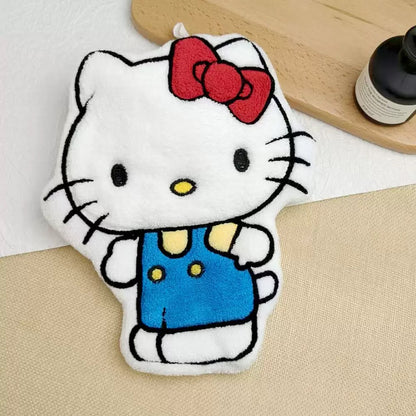 Hello Kitty plush toy with a red bow on a beige surface