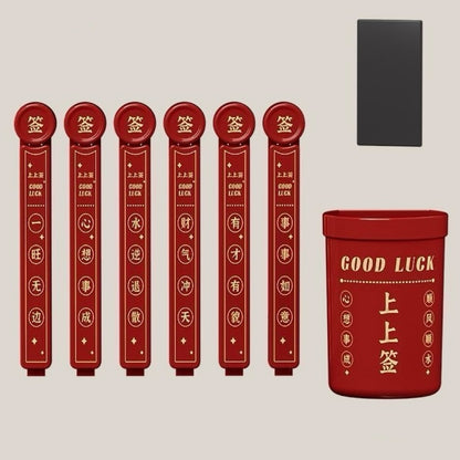 Set of red fortune sticks with a container labeled 'Good Luck' on a beige background