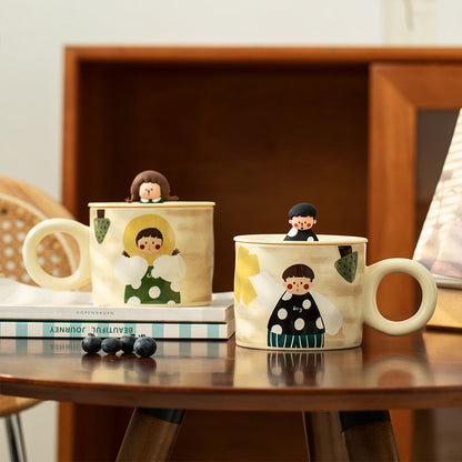 Aesthetic ceramic couple mugs with cute illustrations and mini figurines, placed on a cozy wooden table with books and blueberries.