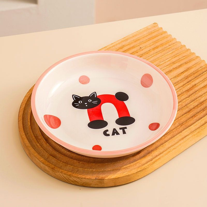 Ceramic bowl with a cat design on a wooden surface
